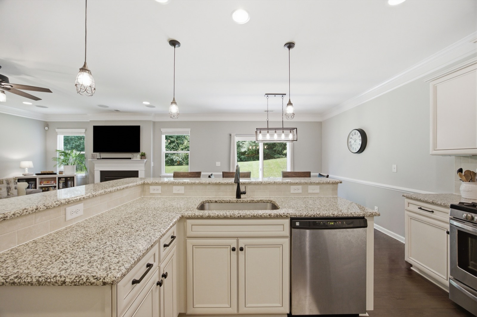 Kitchen with granite counters and a peninsula, open to the living room and dining area
